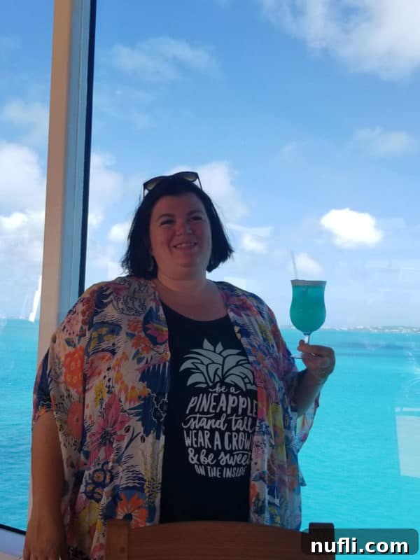 Vibrant Blue Margarita 5 Tammilee holding a blue margarita with the ocean in the background