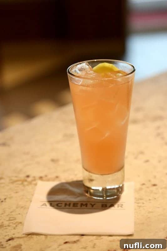 Alchemy Bar's Cucumber Sunrise Elixir Recipe 4 Cucumber Sunrise cocktail on an Alchemy Bar Napkin