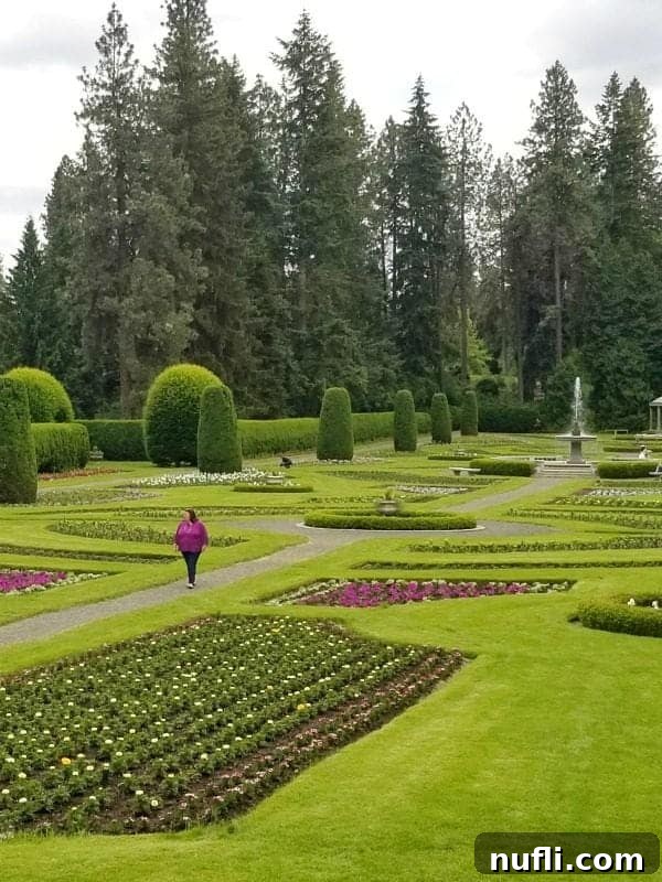 Spokane Washington Adventures Your Ultimate Guide 4 Tammilee walking through Manito Gardens with flowers and green grass