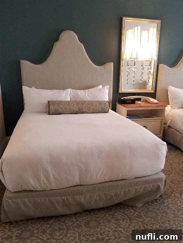 Portofino hotel deluxe 2 queen room with bed and nightstand