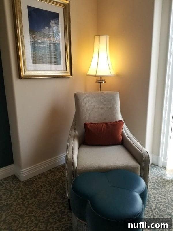 chair in the corner of the room with a lamp behind it