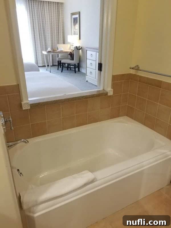 bathtub with a window out to the bedroom 