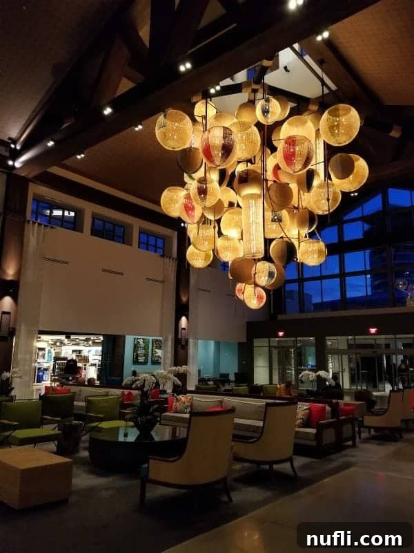 Loews Sapphire Falls lobby featuring a unique beach ball chandelier and Caribbean-inspired decor