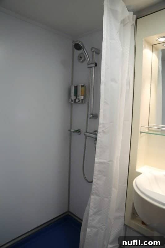 Functional shower in a Carnival Imagination stateroom bathroom.