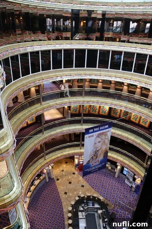 The impressive multi-story atrium of the Carnival Imagination, adorned with grand architecture and open spaces.