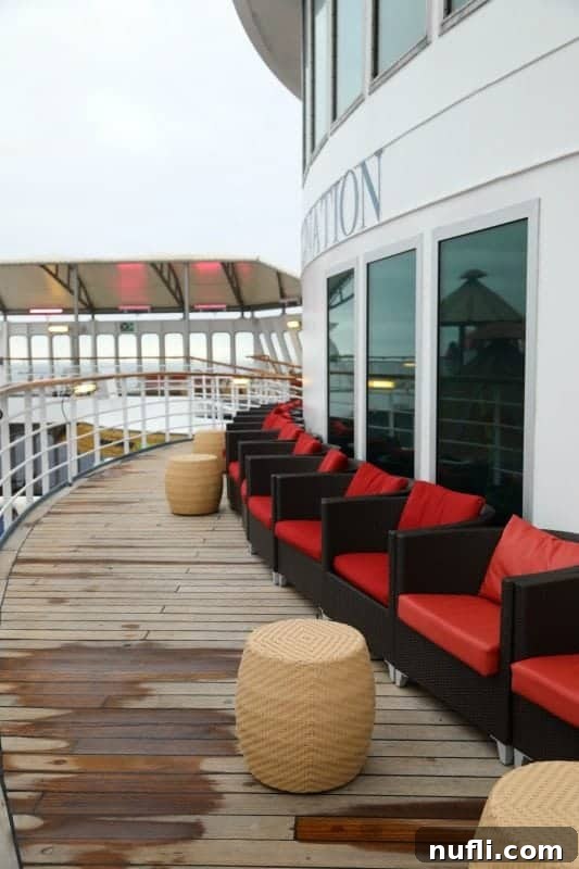 Rows of comfortable deck chairs arranged on the upper deck of the Carnival Imagination, providing ample space for relaxation.