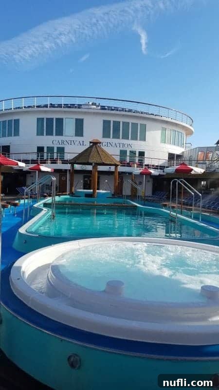 Carnival Imagination's inviting outdoor pool and adjacent hot tub.