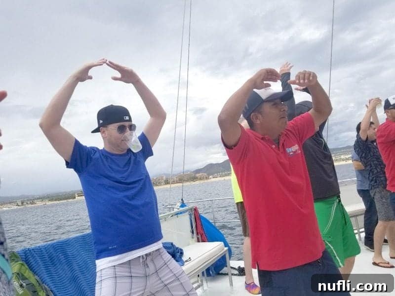Cabo San Lucas Sail and Snorkel Bash 7 People happily dancing and enjoying themselves on the spacious deck of a catamaran during the Sail and Snorkel Fiesta in Cabo San Lucas.