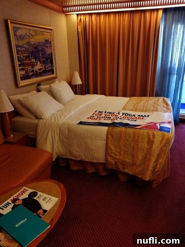 Carnival Splendor stateroom with curtains drawn, showcasing a cozy bed and inviting ambiance.