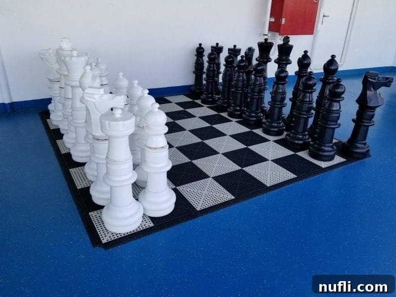 Giant checkers game set up on the pool deck, offering classic fun for all ages.