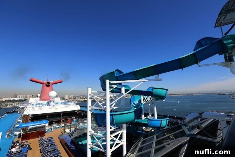 Carnival splendor waterslide and iconic Carnival funnel near the pool deck, creating a vibrant water park.