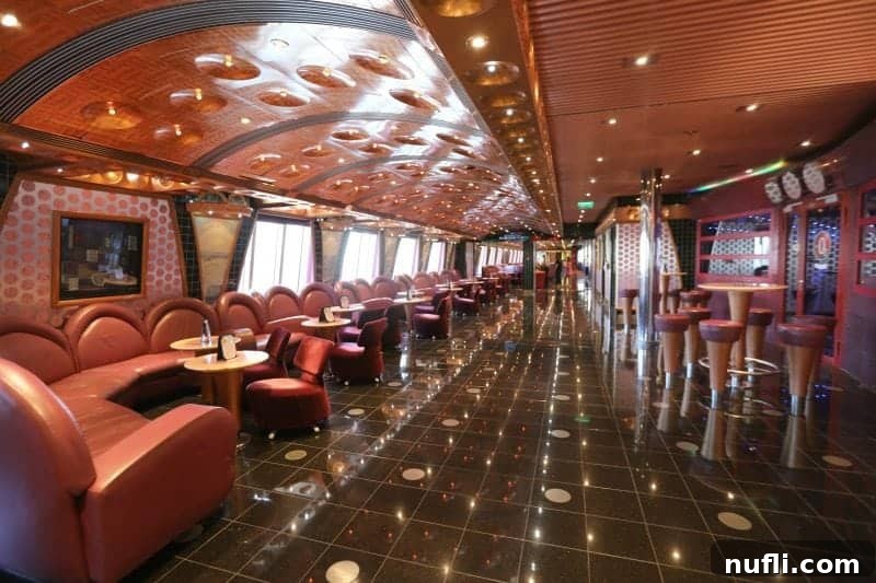 A serene walkway on the promenade deck, lined with inviting padded benches and chairs, perfect for relaxation and enjoying the view.