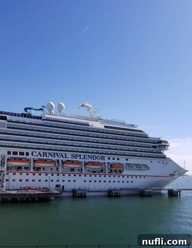 The impressive Carnival Splendor cruise ship docked in port, ready for its next exciting voyage.