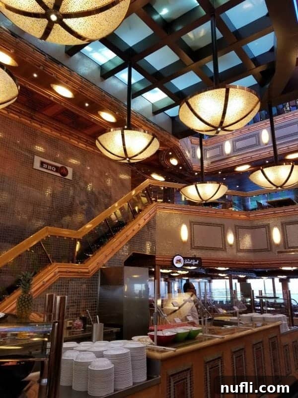 Spacious Carnival Splendor buffet area with inviting stairs leading up to a BBQ sign, promising a variety of delicious options.
