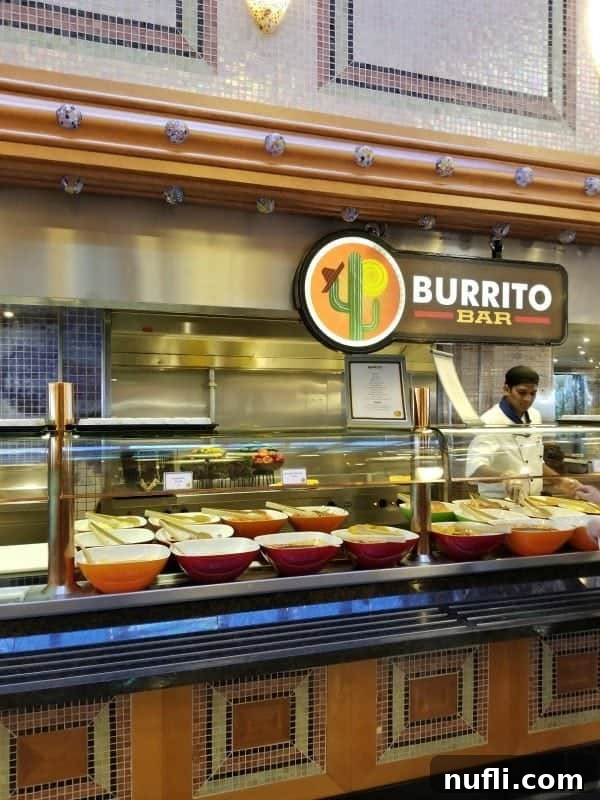 Burrito bar sign over a chef dishing out food from bowls on the buffet, highlighting a popular option.
