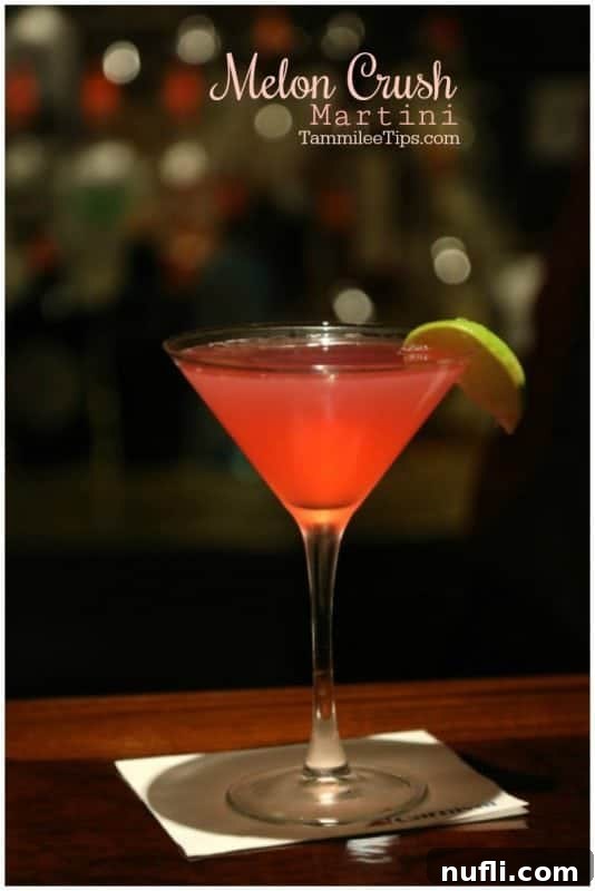 This delicious Melon Crush Martini Recipe is the perfect combination of cranberry and watermelon to make a great cocktail. All you need is vodka and a few ingredients to make this great cocktail recipe. Great for holiday parties or date night at home. #cocktail #martini #recipe #melon #easyrecipe #cocktailrecipe #watermelon #cranberry Melon Crush martini over a pink martini sitting on a Carnival napkin