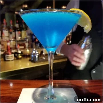 Sea Blue Martini in a martini glass with lemon wedge
