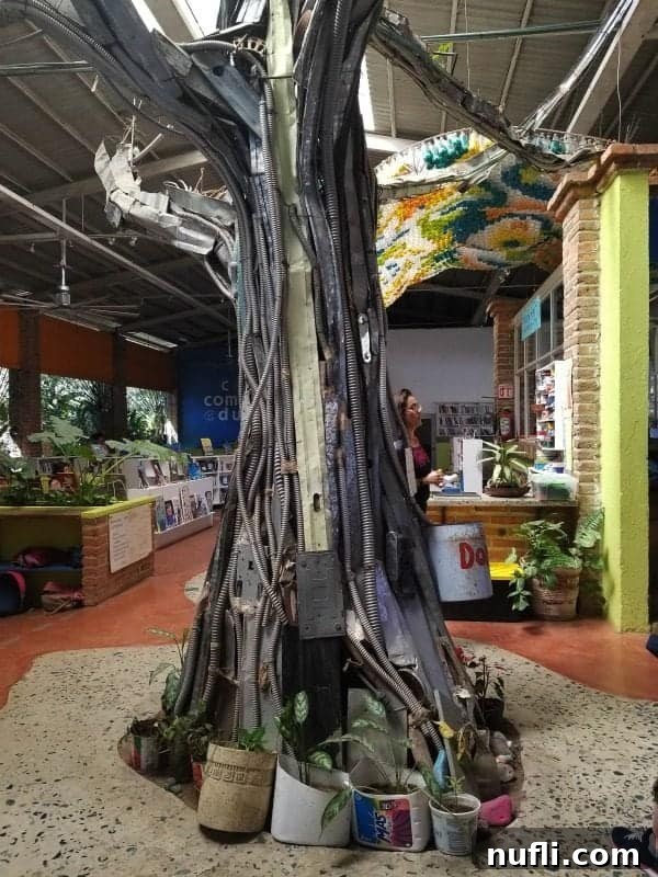 tree made with recycled garbage in the middle of a library 