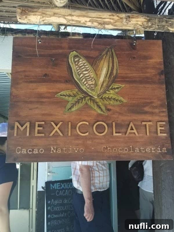 Mexicolate cacao nativo sign with people walking behind it 