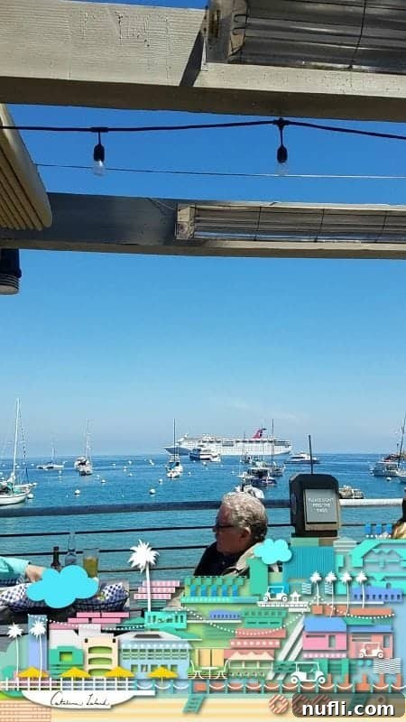 A scenic view across the calm harbor waters, showcasing a large Carnival cruise ship docked in the distance, framed by palm trees and the picturesque coastline of Catalina Island.