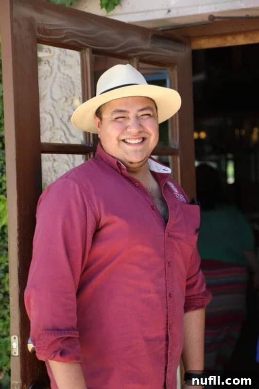 man standing at a door with a big smile 