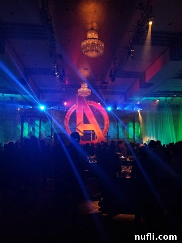 A dazzling Avengers 'A' logo centerpiece, glowing brightly at the exclusive Infinity War afterparty.