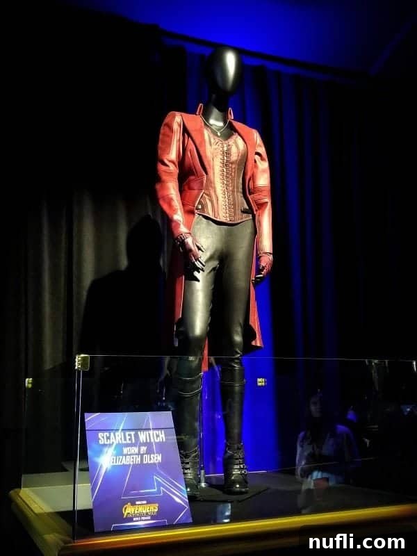 The detailed Scarlet Witch costume worn by Elizabeth Olsen, highlighting her mystical powers and elegant design.