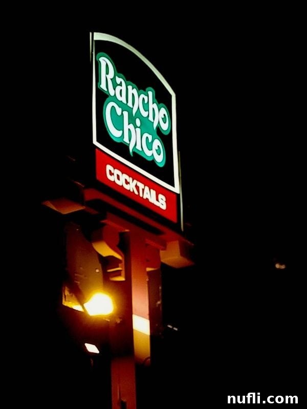 Rancho Chico sign lit up at night
