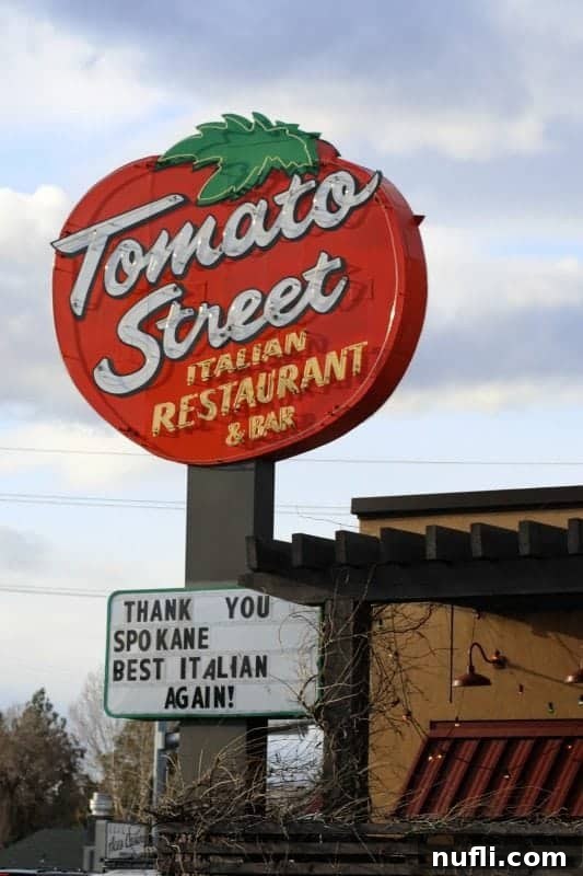 Tomato Street Italian Restaurant sign over a restaurant and sign with thank you spokane 
