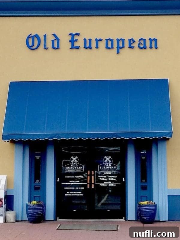 Old European sign over a blue awning and entrance sign
