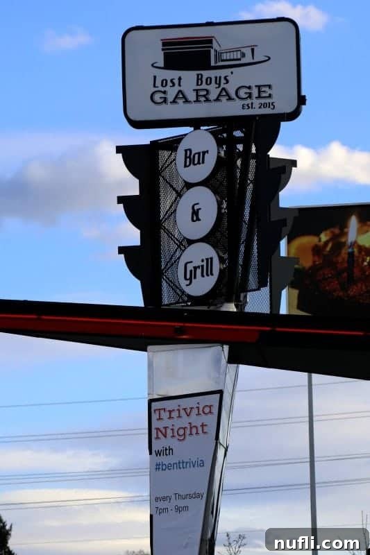 Lost Boys Garage bar and grill sign over trivia night sign