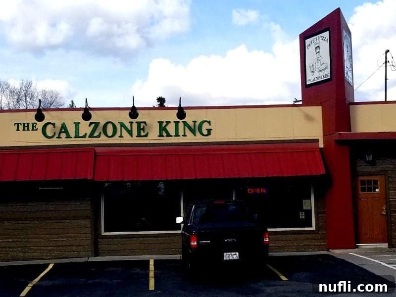 The Calzone King sign over a red awning with a truck parked and Pete's Pizza sign