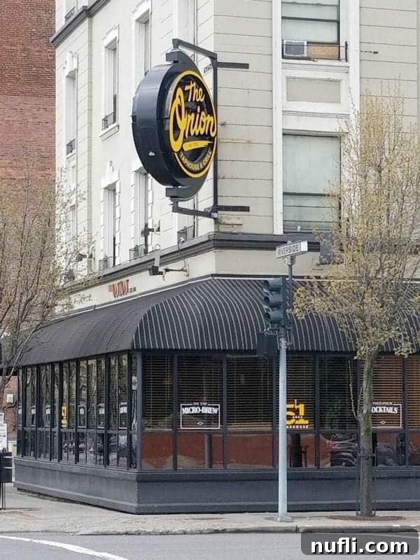 The Onion circle sign over a walkway and building entrance