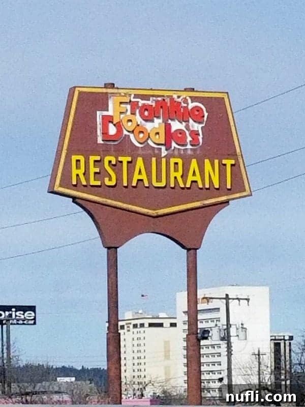 Frankie Doodles Restaurant sign with building behind it
