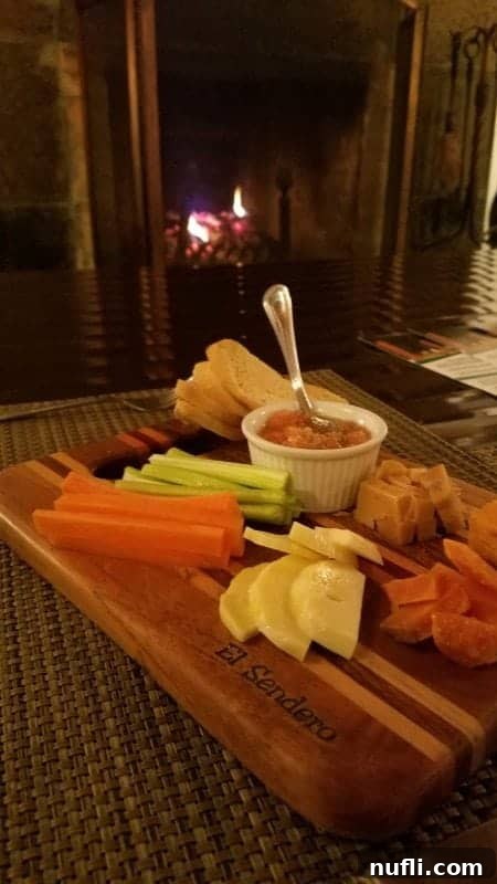 A delightful platter featuring artisan bread, savory cheese, and a colorful assortment of fresh tropical fruits, perfect for a relaxing evening.