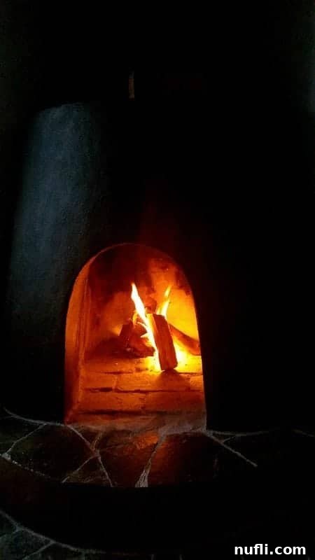 A close-up shot of a cozy fire crackling in the fireplace of a Villa Blanca casita, providing warmth and ambiance.