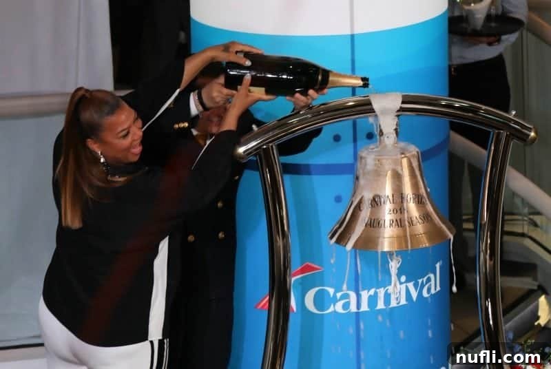 Close-up shot of Queen Latifah pouring champagne over the Carnival Horizon's ceremonial bell, signifying good luck and prosperity