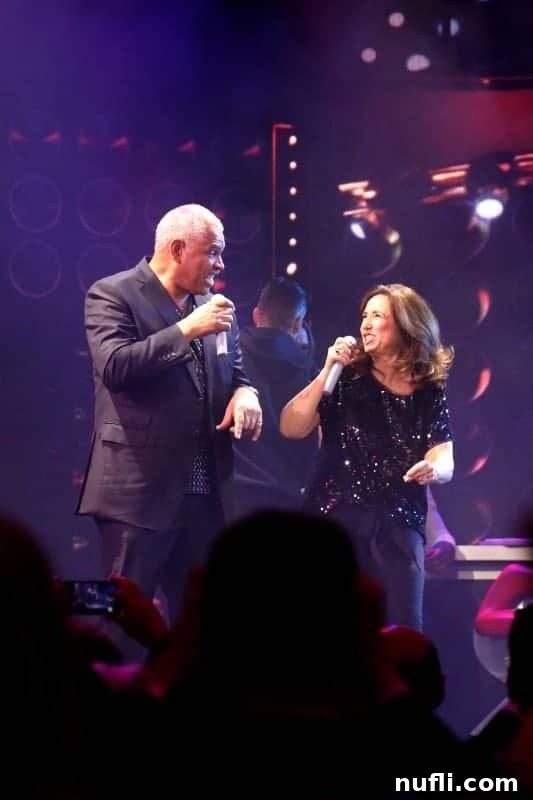 Christine Duffy, President of Carnival Cruise Line, and Arnold Donald, CEO of Carnival Corporation, performing energetically during the Lip Sync Battle on stage