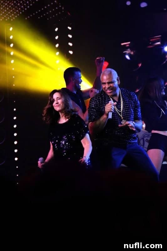 Christine Duffy and Arnold Donald engaging with the enthusiastic audience during their lively Lip Sync Battle performance on the Carnival Horizon