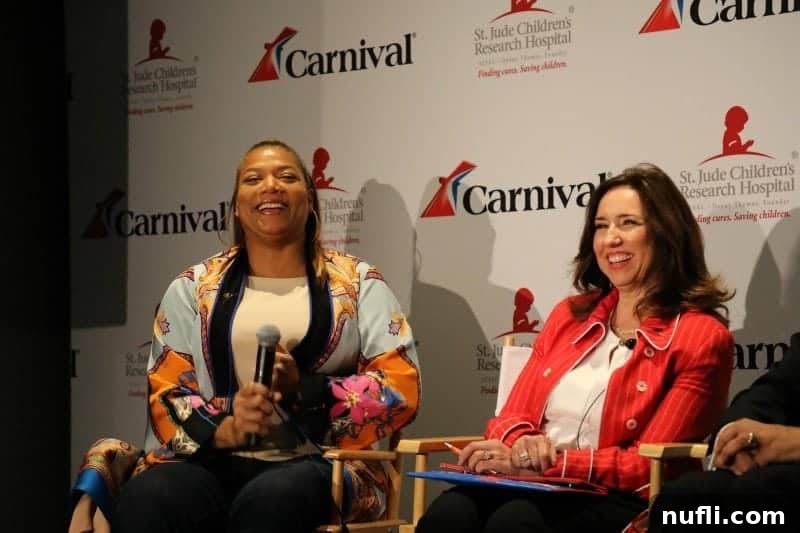 Queen Latifah and Christine Duffy on stage during the Carnival Horizon Inaugural event with the iconic Carnival logo prominently displayed in the background