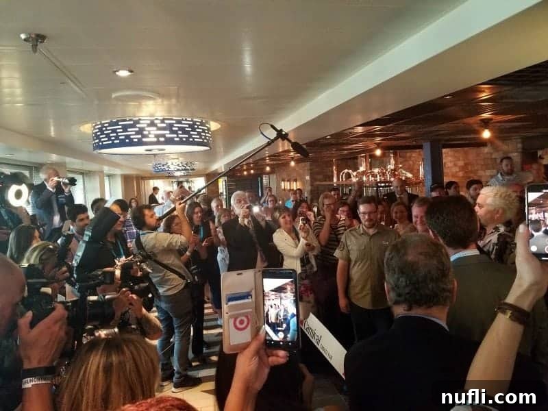 Guy Fieri cutting the ribbon for the Pig & Anchor Smokehouse and Brewery, surrounded by excited onlookers and Carnival officials