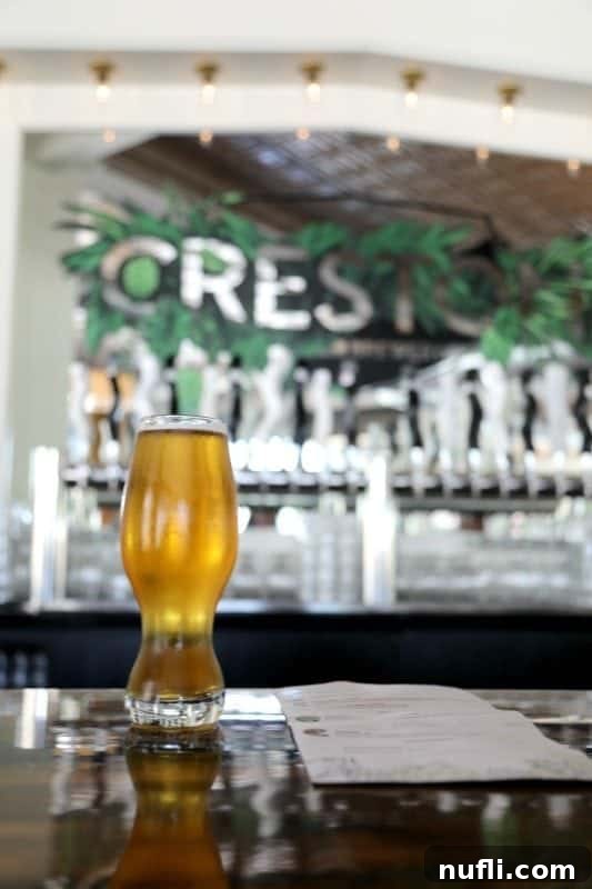 Beer on a counter with brewery crest in the background