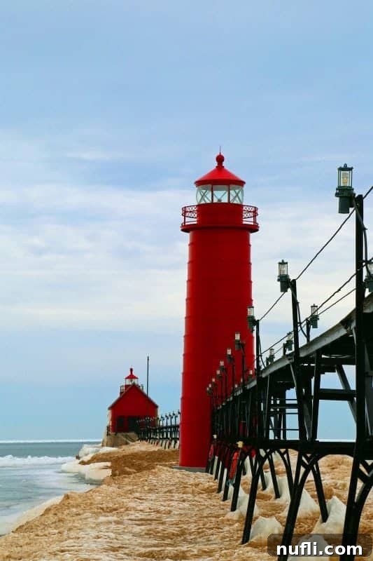 Grand Haven lighthouse with ice around it in winter