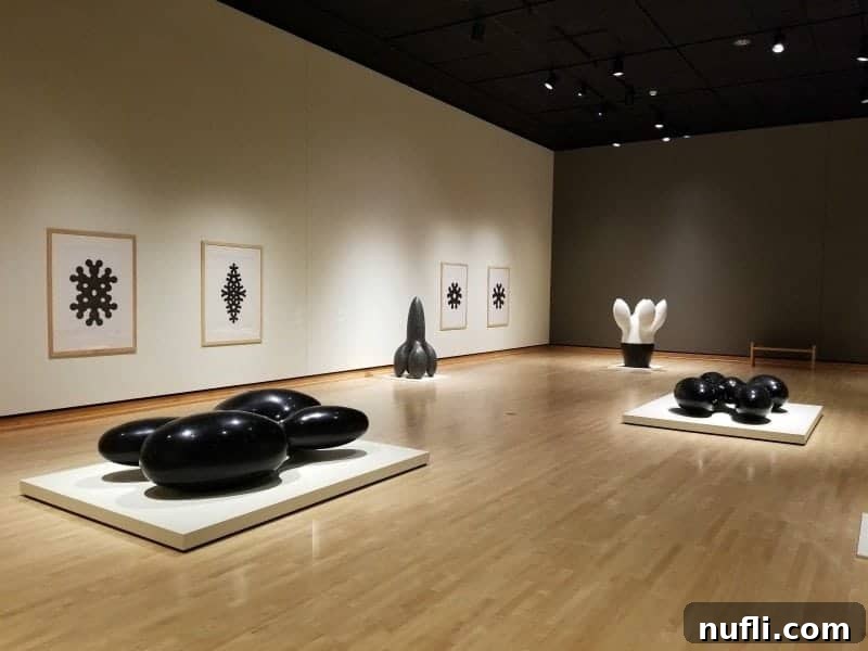 Black and white sculptures in a modern art gallery setting
