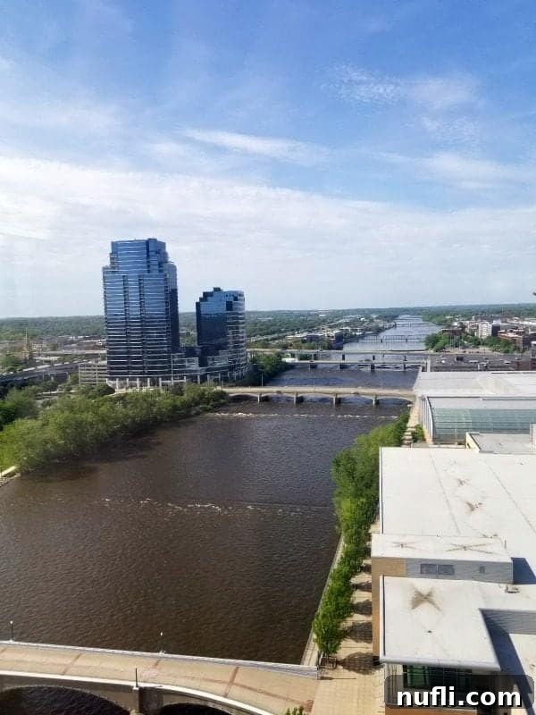 Looking out over the Grand River to tall buildings from a high floor at the Amway Grand Plaza
