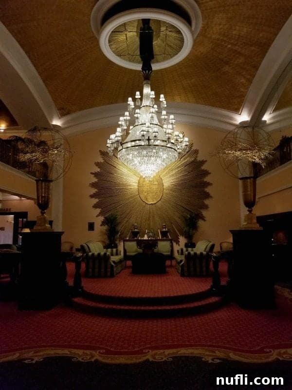 Gorgeous crystal chandelier hanging elegantly in a historic hotel lobby area