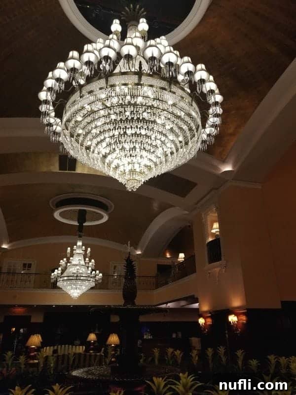 Grand lobby of the historic hotel adorned with multiple large crystal chandeliers and an intricate gold-leaf ceiling, exuding timeless elegance