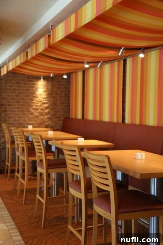 Spacious and brightly decorated buffet dining area on the Carnival Horizon with various food stations and comfortable seating.