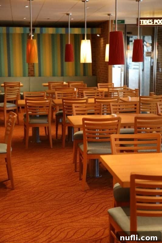 Another view of the expansive Lido dining room, with Tides Pool signage visible, indicating proximity to exciting outdoor pool areas.