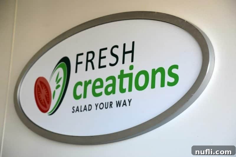 The Fresh Creations Salads Your Way sign, indicating a healthy and customizable dining option on the Carnival Horizon.